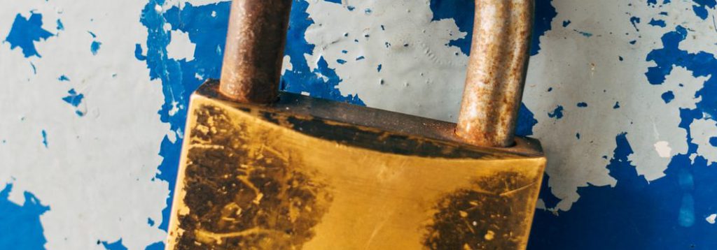 gold padlock on blue and white floral door